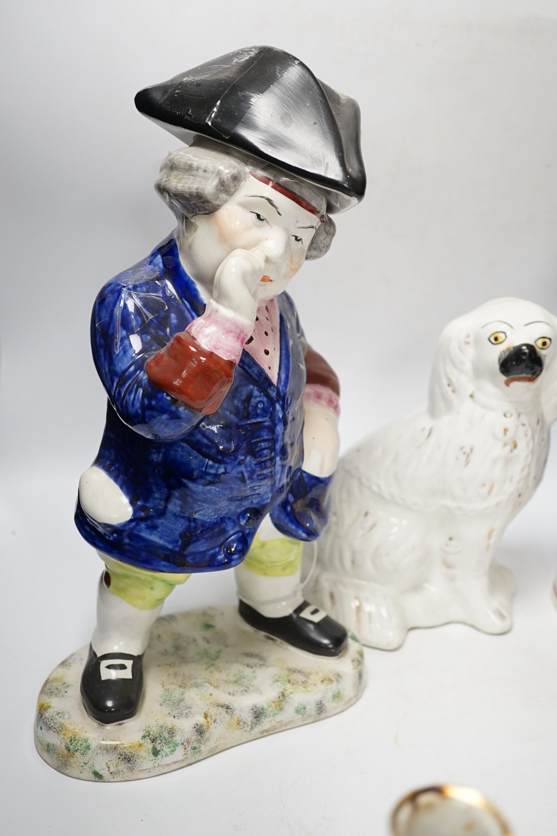 A pair of 19th century French figural two branch candelabra, 17cm high, together with two Staffordshire character jugs and a pair of Kings Charles Spaniel figures